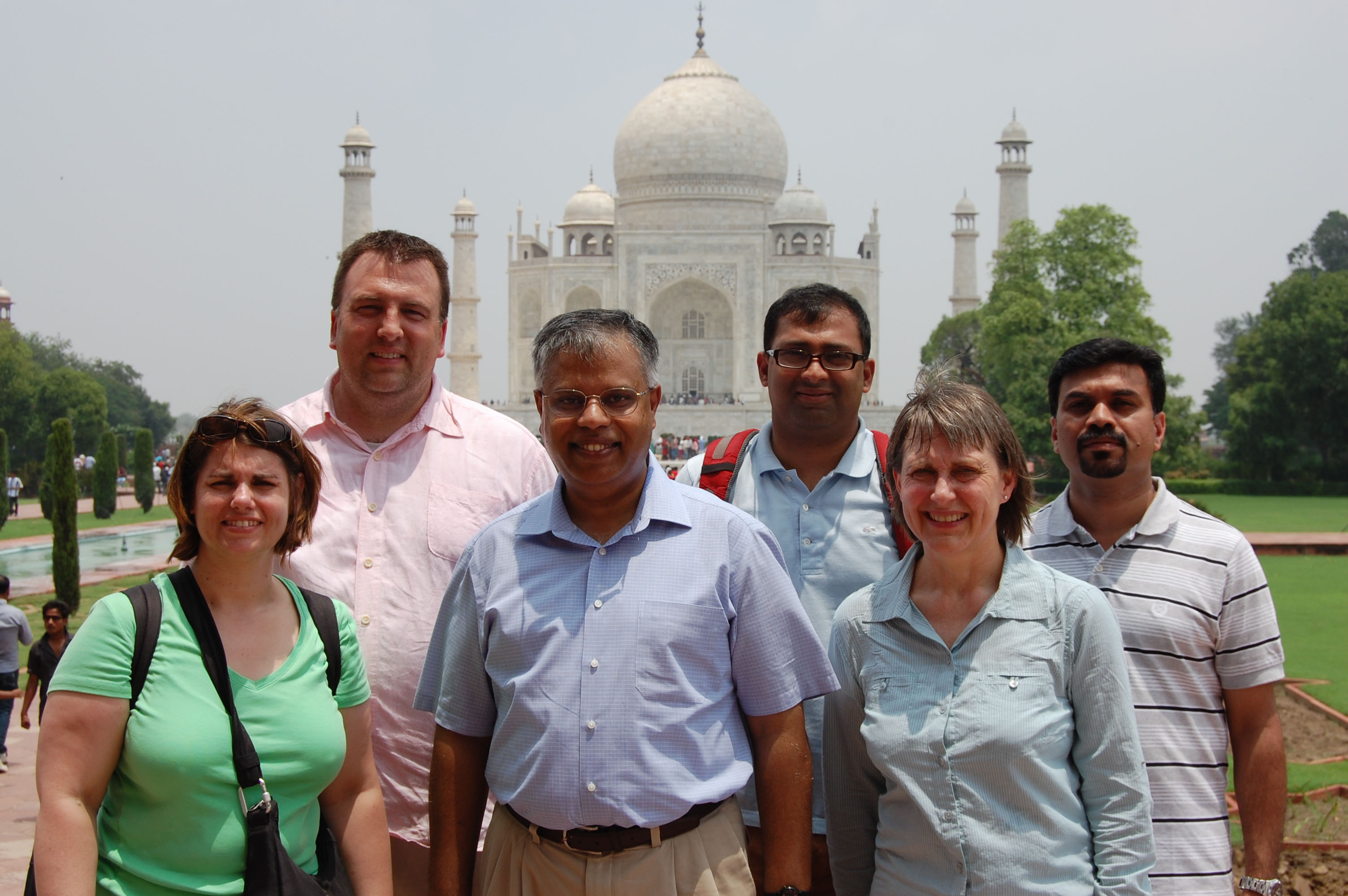 people posing in front of taj mahal